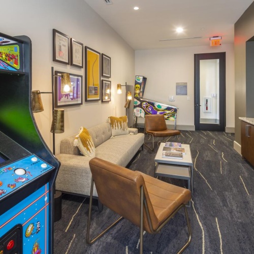 a room with arcade games and a couch