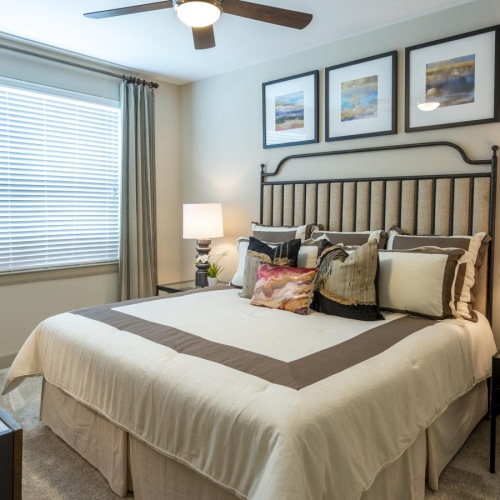 a bedroom with a bed and a fan