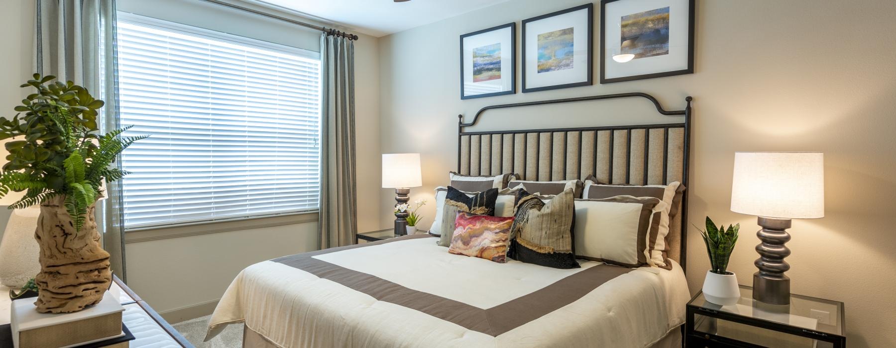 a bedroom with a bed and a fan