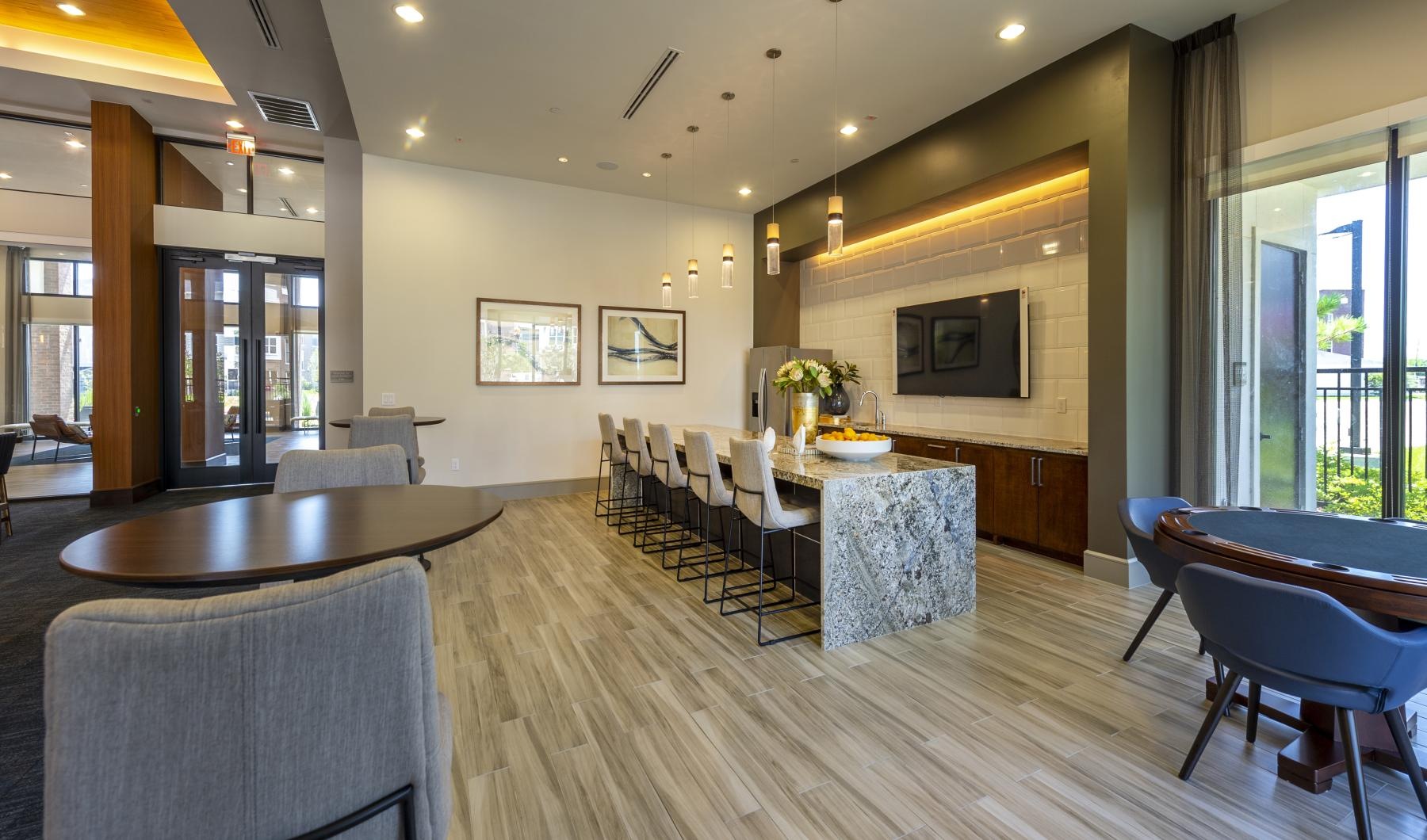 a large room with a bar and chairs